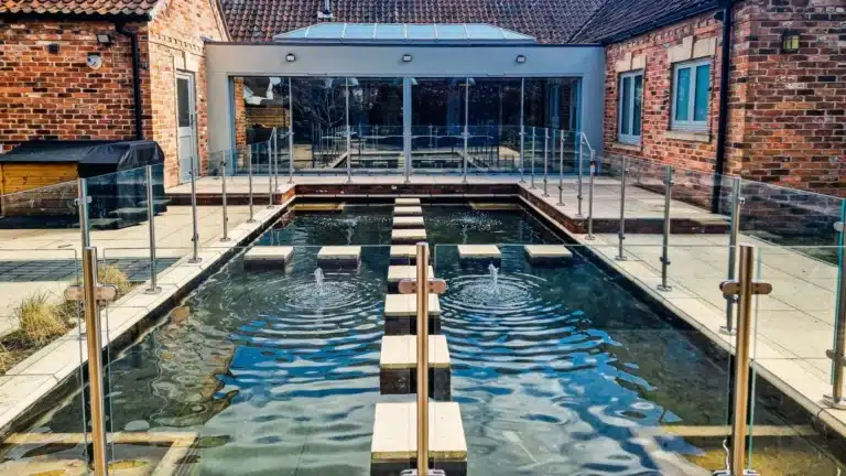 garden patio pond with glass balustrade surroundings