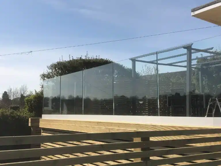 Wooden frame raised deck with a frameless glass balustrade railing