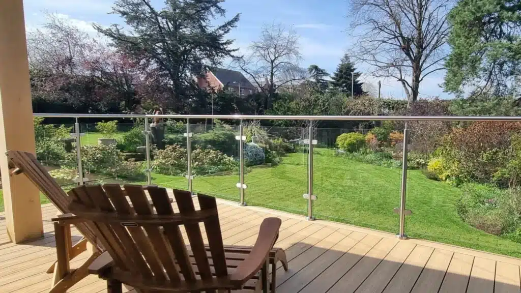 glass balustrade with posts and handrail around a decking area