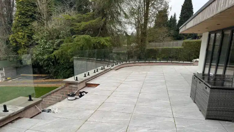 vision-glass-balustrade-with-black-powder-coated-spigots-around-a-raised-patio