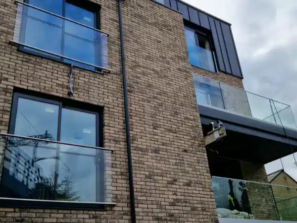 Modern Brick building with Juliet balconies overlooking glass balustrades